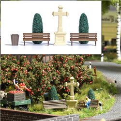 Park benches, trees (thujas) and stone cross